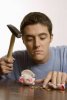 young-man-with-hammer-and-broken-piggy-bank-LDF00473.jpg
