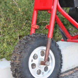 red minbike left side fork and wheel