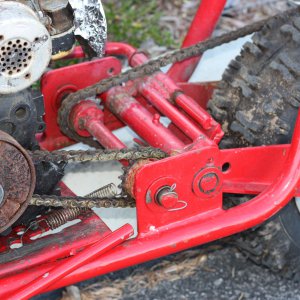 red minibike left side rear wheel closeup